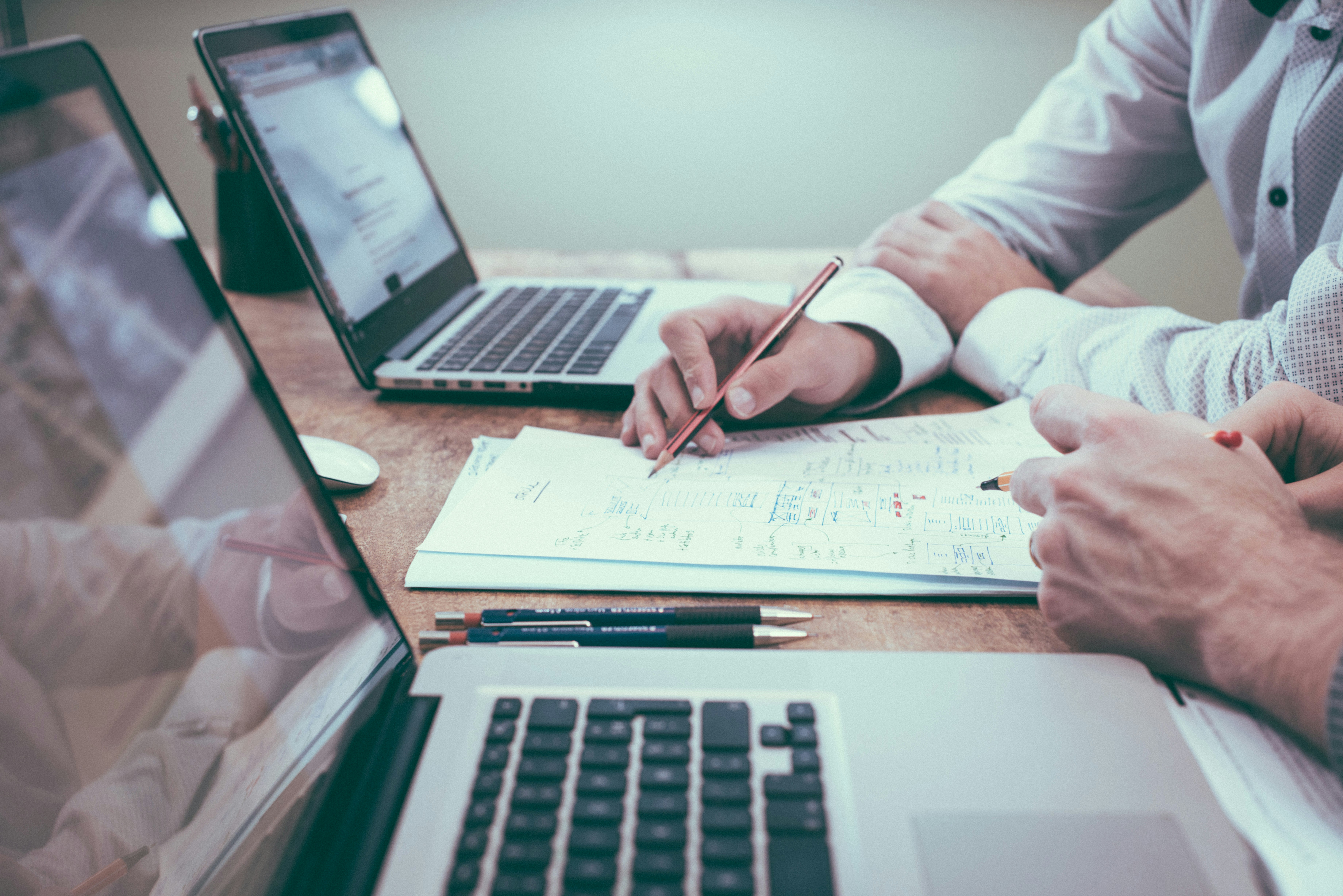Person reviewing notes and paperwork during a needs assessment