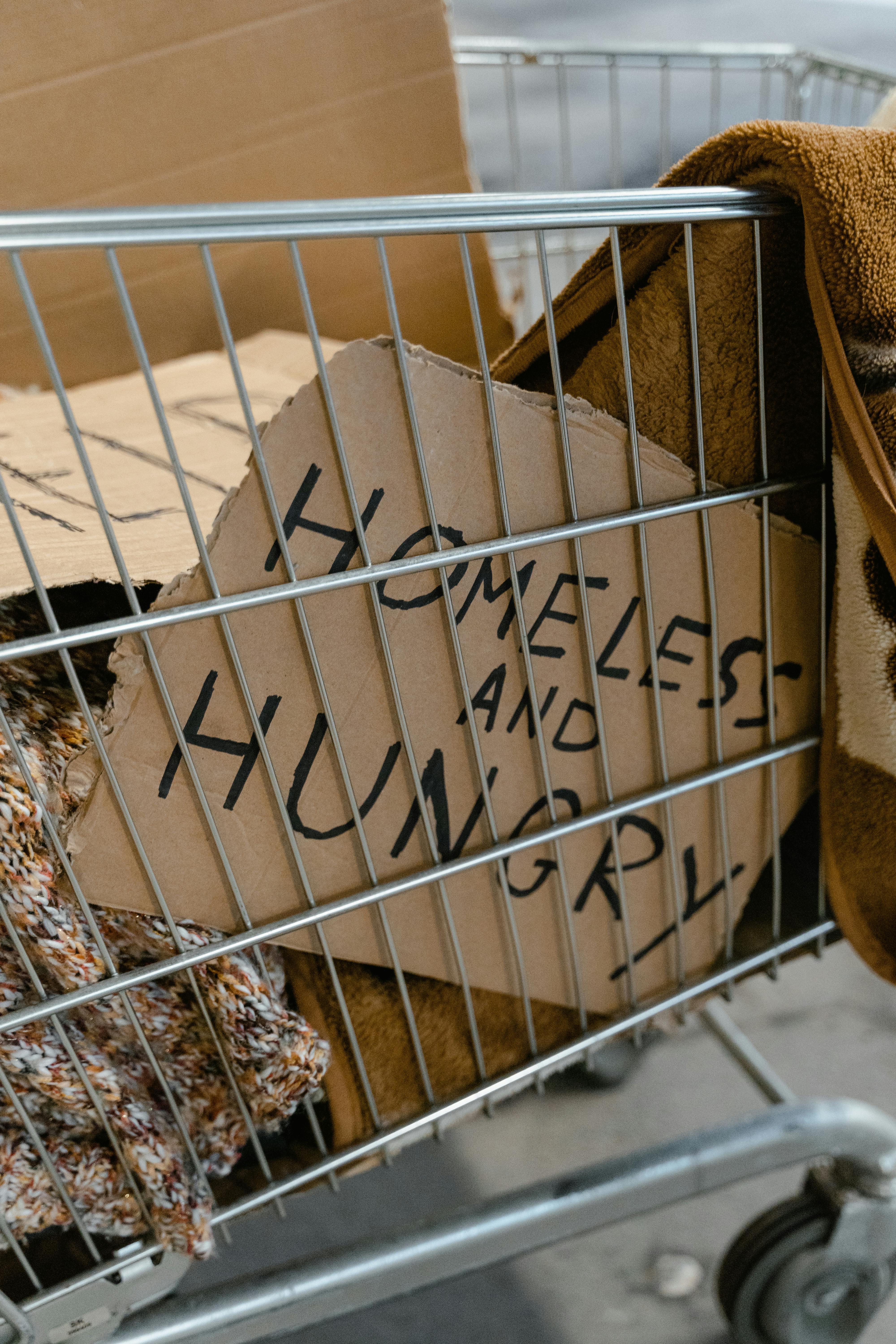 Person sitting with belongings on a city street